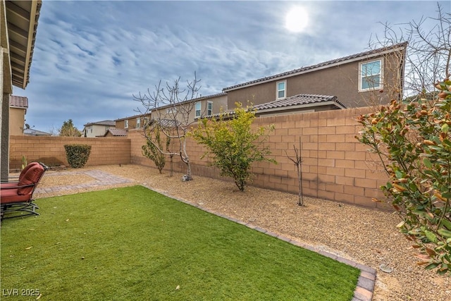 view of yard with a fenced backyard