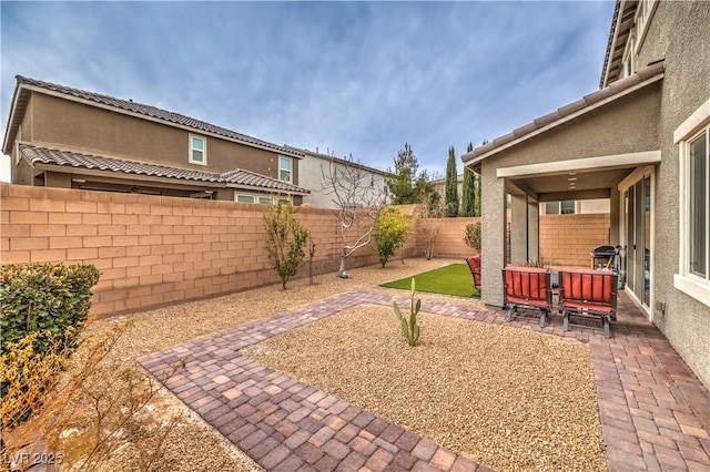 view of yard featuring a patio area and a fenced backyard