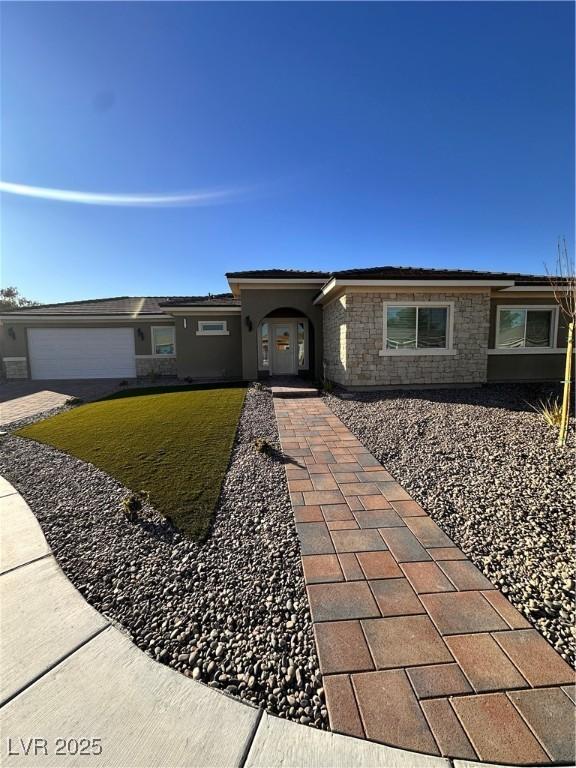 single story home with a garage and a front yard