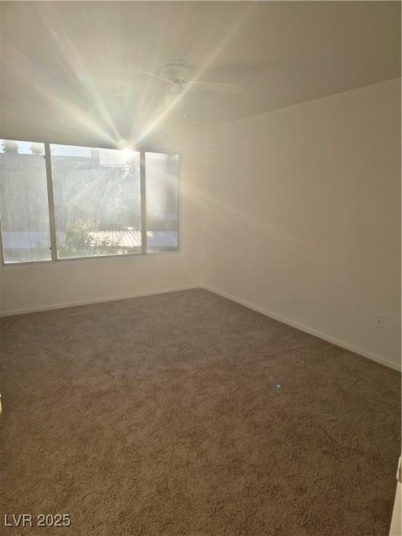 carpeted empty room with ceiling fan