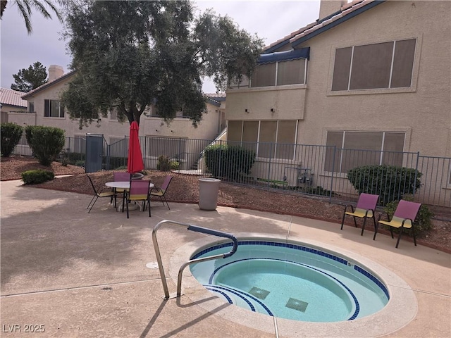 view of pool featuring a patio area and an in ground hot tub