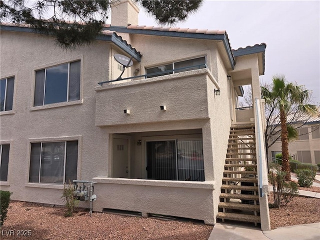 rear view of property with a balcony