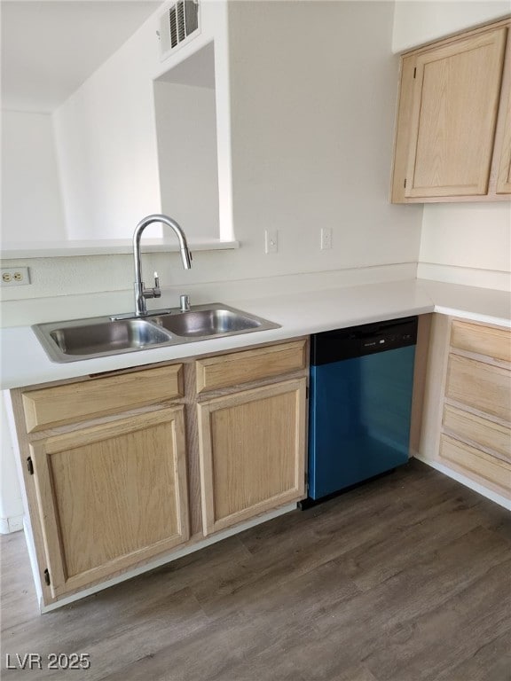 kitchen with dark hardwood / wood-style floors, sink, stainless steel dishwasher, and light brown cabinets