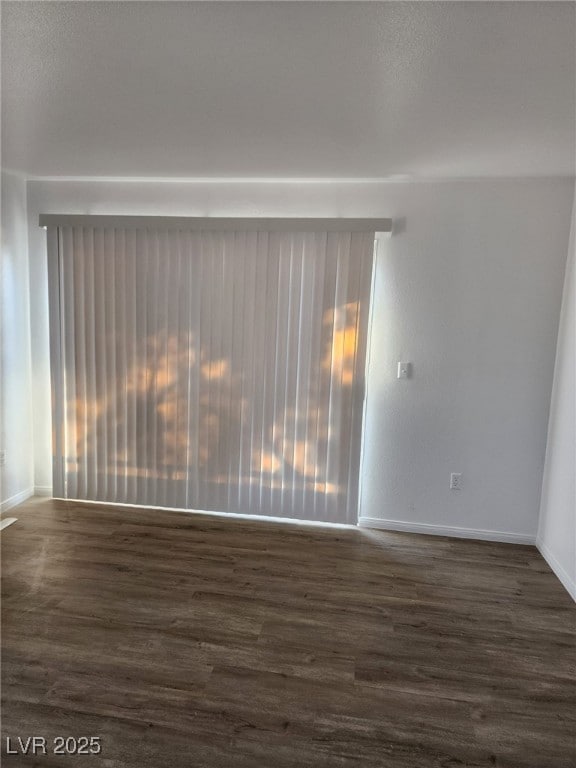 spare room with dark hardwood / wood-style flooring