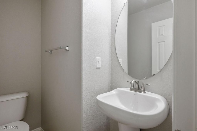 bathroom with sink and toilet