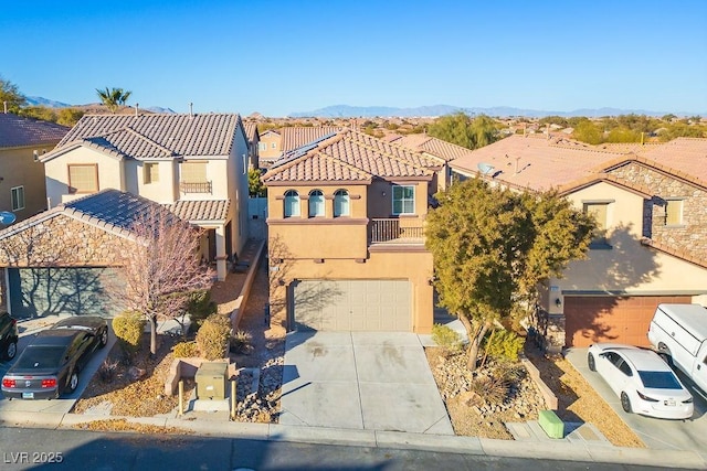 view of front of property with a garage, a balcony, and a mountain view