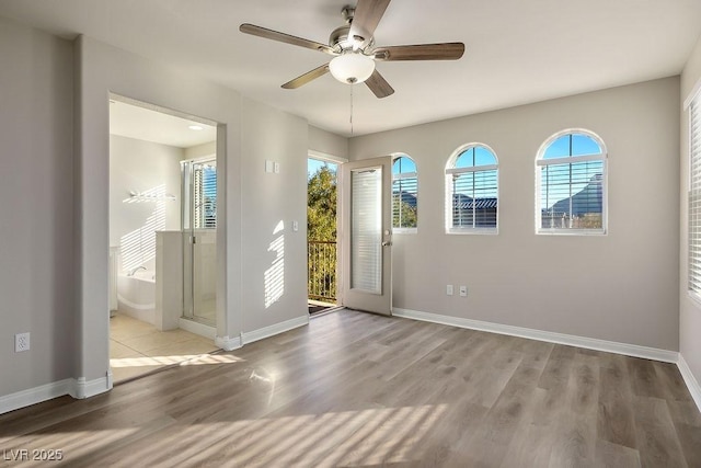 doorway with light hardwood / wood-style flooring and ceiling fan