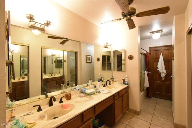 bathroom featuring ceiling fan, vanity, an enclosed shower, and tile patterned flooring