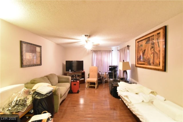 living room with hardwood / wood-style flooring and a textured ceiling