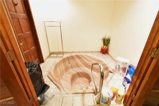 bathroom with tile patterned flooring and a tub to relax in