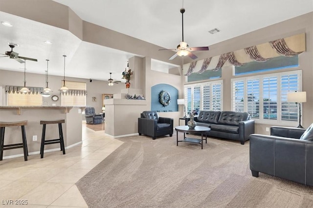 living room with ceiling fan and light tile patterned flooring