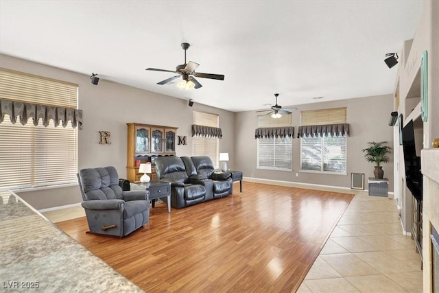 living room with ceiling fan and light wood-type flooring