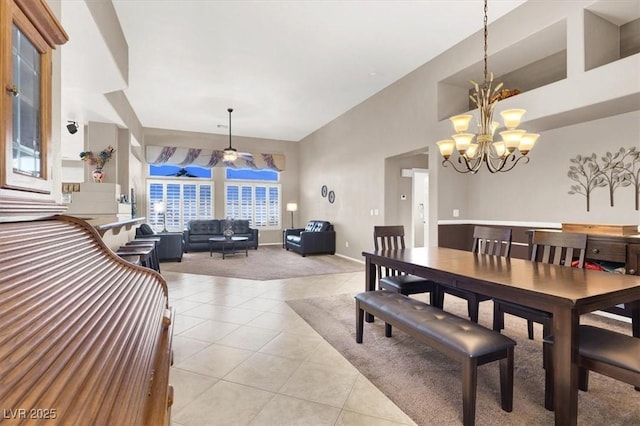 dining room featuring ceiling fan with notable chandelier and light tile patterned floors