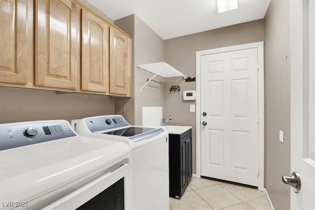 washroom with washer and dryer, sink, cabinets, and light tile patterned flooring