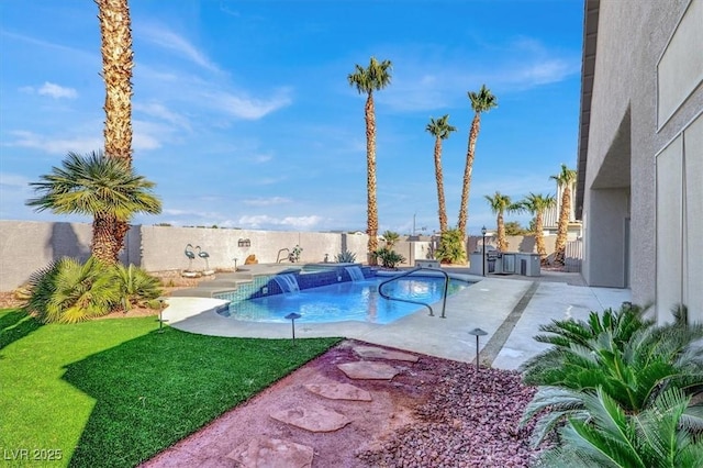 view of swimming pool with pool water feature, a lawn, and a patio area