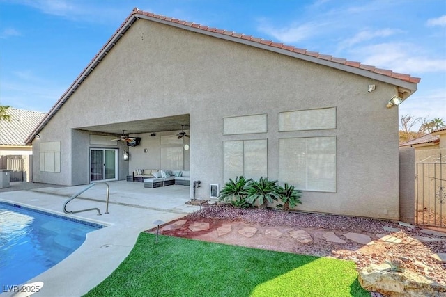 rear view of property featuring an outdoor hangout area, ceiling fan, and a patio area