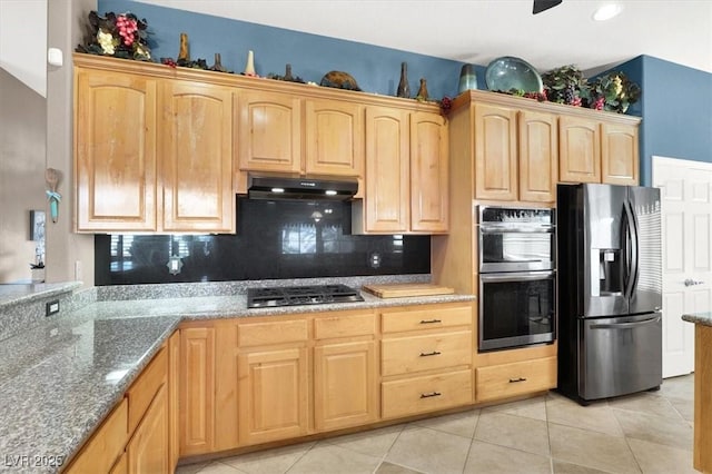 kitchen featuring light tile patterned floors, backsplash, stainless steel appliances, light stone counters, and light brown cabinetry