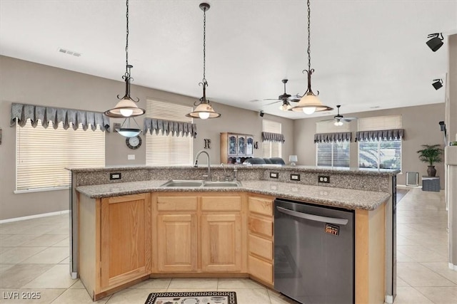 kitchen with a center island with sink, sink, stainless steel dishwasher, and decorative light fixtures