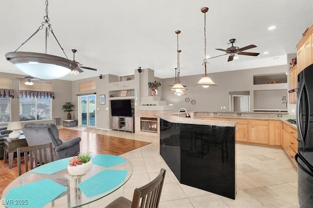 tiled dining space with sink and ceiling fan