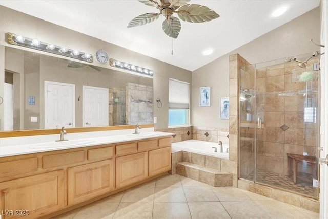 bathroom featuring vaulted ceiling, vanity, ceiling fan, plus walk in shower, and tile patterned flooring