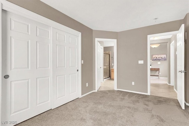 unfurnished bedroom with a closet and light carpet