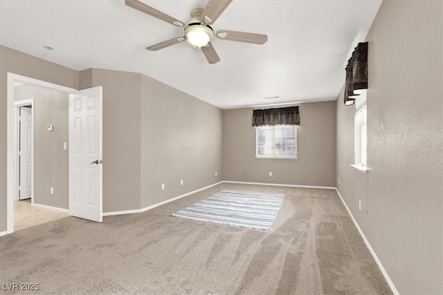 empty room with light carpet and ceiling fan