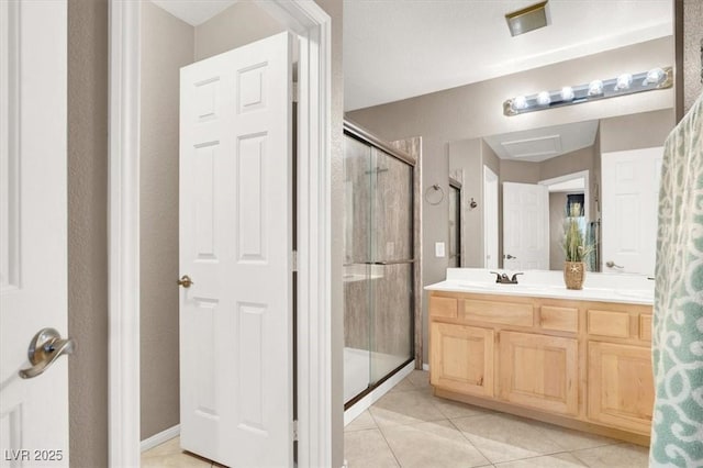 bathroom featuring tile patterned floors, vanity, and a shower with door