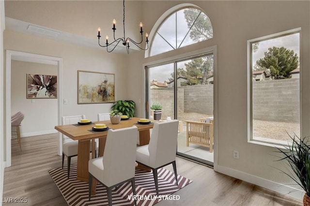 dining space with a chandelier and light hardwood / wood-style flooring