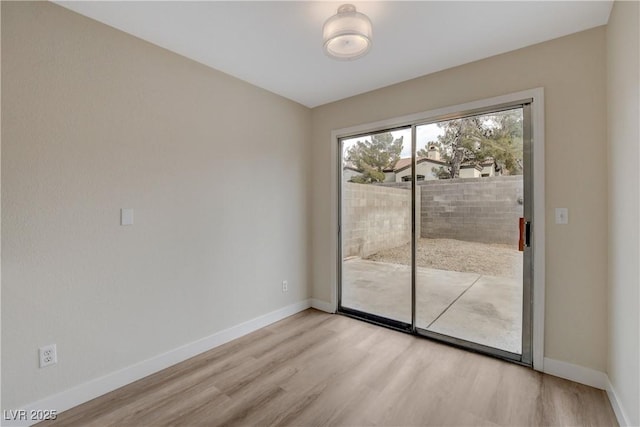 spare room with light hardwood / wood-style flooring