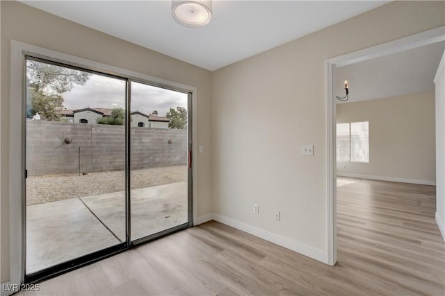 doorway to outside with light hardwood / wood-style floors and a wealth of natural light