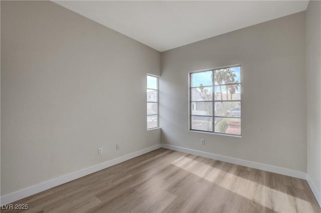 spare room with light hardwood / wood-style flooring