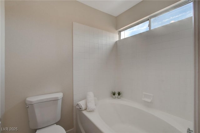 bathroom with a washtub and toilet