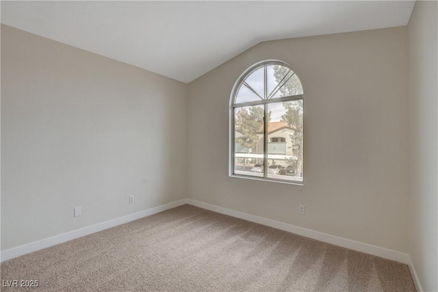 unfurnished room featuring vaulted ceiling and carpet floors