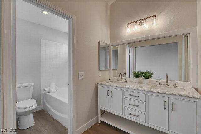 bathroom featuring wood-type flooring, vanity, and toilet