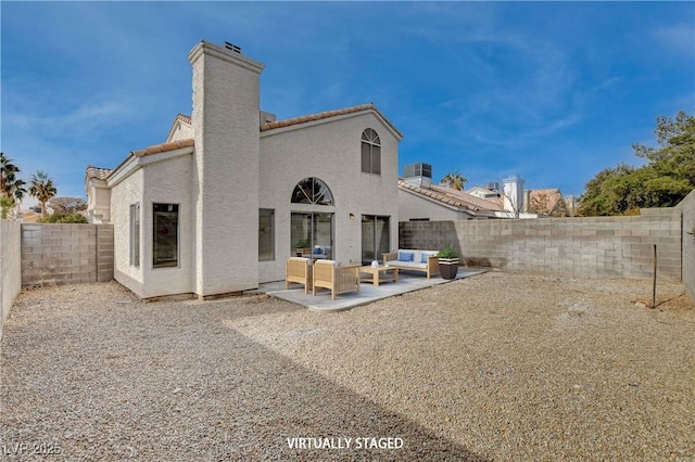 rear view of house featuring a patio and outdoor lounge area