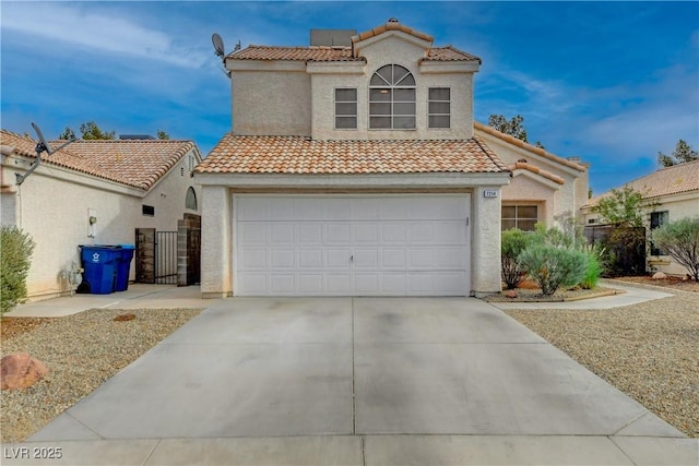 mediterranean / spanish home with a garage