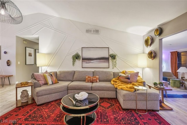 living room with vaulted ceiling and hardwood / wood-style floors