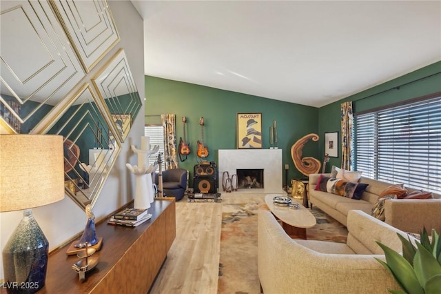 living room with vaulted ceiling and hardwood / wood-style floors