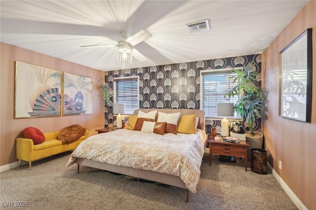 bedroom featuring multiple windows, ceiling fan, and carpet