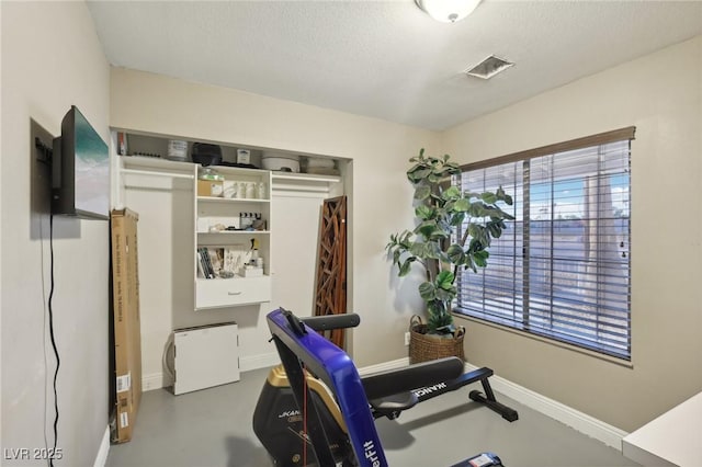 workout area featuring a textured ceiling