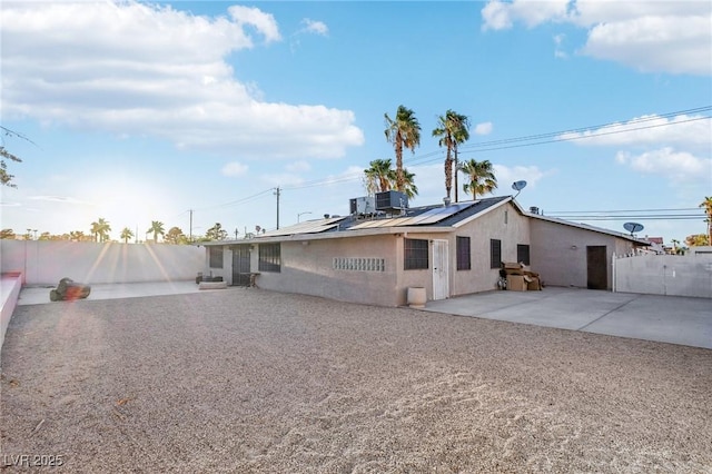 back of house featuring a patio and solar panels