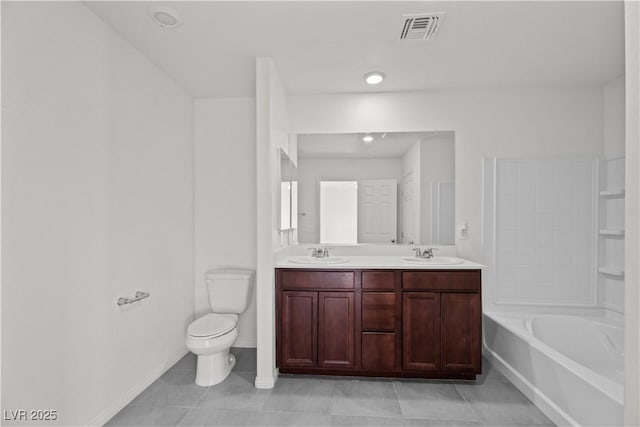 bathroom featuring tile patterned flooring, vanity, and toilet