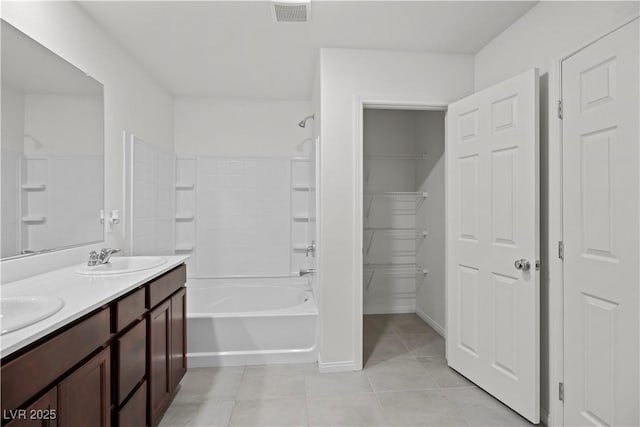 bathroom featuring tile patterned flooring, vanity, and shower / bathtub combination