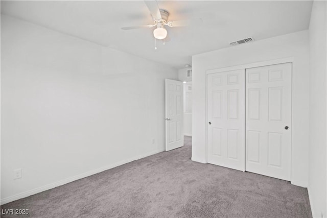 unfurnished bedroom featuring carpet floors, a closet, and ceiling fan