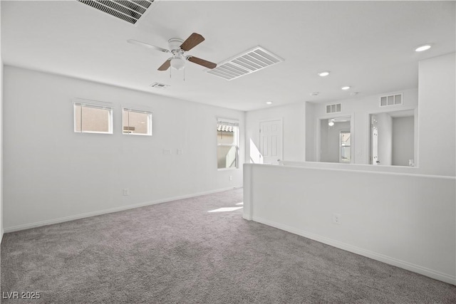 unfurnished room featuring ceiling fan and carpet flooring