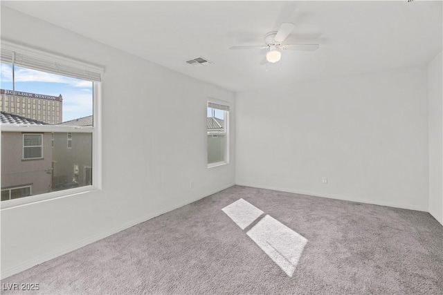 carpeted empty room with ceiling fan