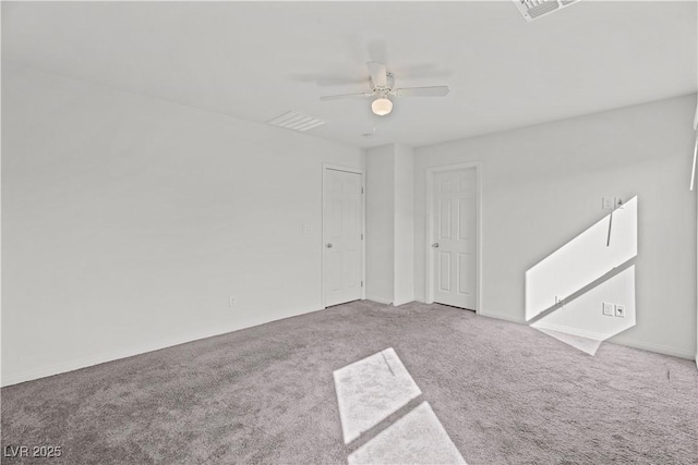 carpeted spare room with ceiling fan