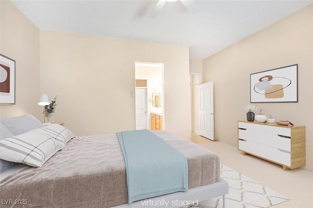 carpeted bedroom featuring ceiling fan and ensuite bath