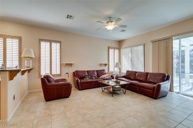 tiled living room with ceiling fan