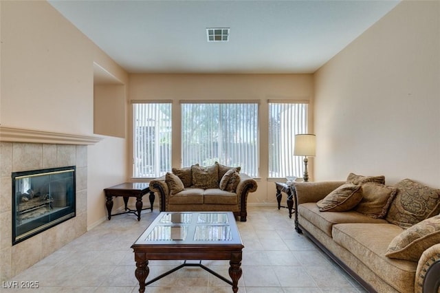 living room featuring light tile patterned flooring and a tiled fireplace